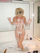 Sonia naked standing in a bubble bath