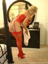 Pictures of a lingerie model wearing red vinyl corset, red thong panties, red stockings, and red high-heels